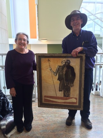 Wallace and Kathleen Piercefield holding up her artwork inspired by the book. 