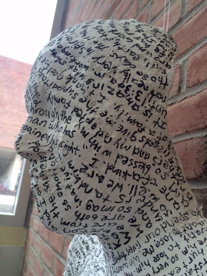 Abby Schlachters cast covered in writing on display at the festival. 