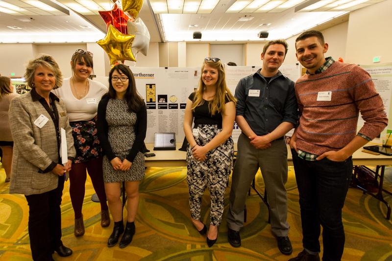 Michele Day, Nancy Curtis, Lindsey, Carrie Crotzer, Matt Spaulding and Kevin Schultz stand by posters at the Celebration poster session on Wednesday. They represented the poster for The Northerner which highlighted digital projects that have been done by the publication over the past year. 