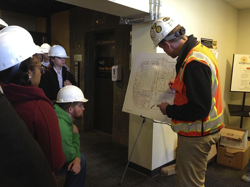 Project Manager JD Barnes shows student government senators the route they will take through the Rec Center construction site. SGA toured the site March 30.