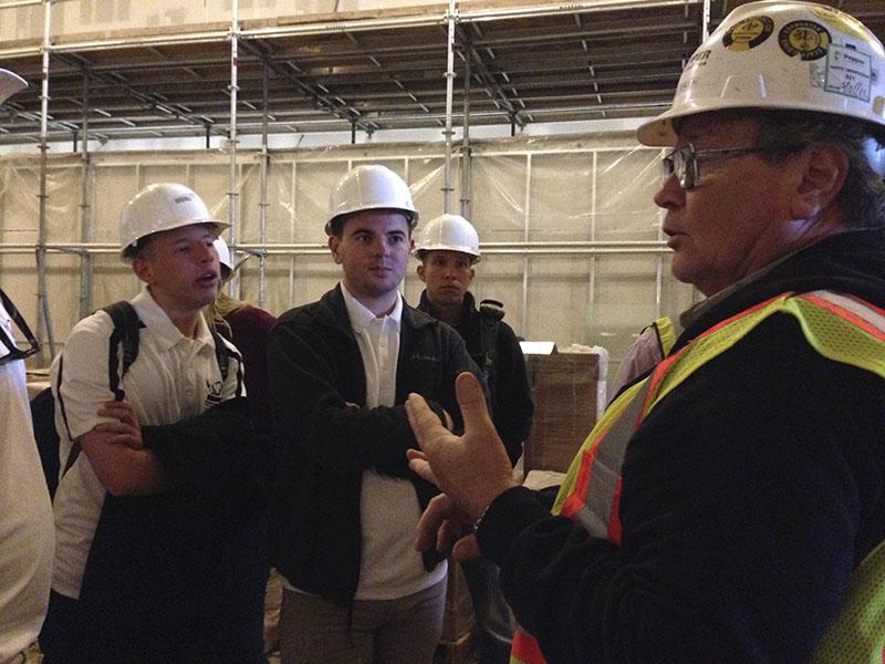 Group Superintendent Joe Deacon explains the work that went into digging out the space for the pool. SGA toured the site March 30.