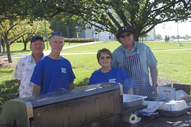 Senior Pastor Rick Fraizer stands with volunteers during the Baptist Center's cookout for freshman.