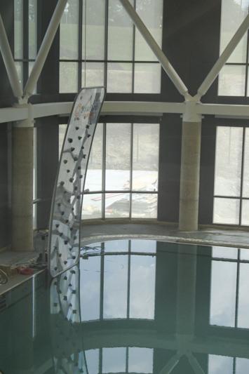 Coming out of the diving pool is a rock wall. The diving pool also features a low and high diving board.