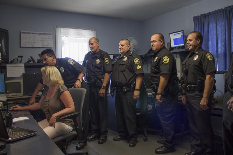 Former Police Chief Leslie Kachurek goes over information with his staff. Kachurek announced his resignation  in June. 