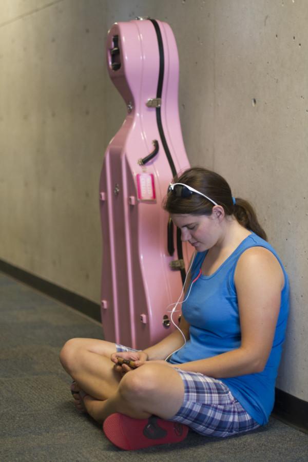 Freshman Nursing major Patricia Iiams sits by her cello 