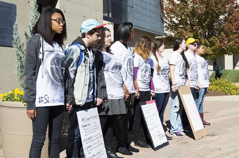 Students stand during the silent protest bringing awareness to school shootings and gun violence. The protest was organized by Students for Social Change.