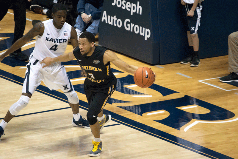 Tyler White (3) works the baseline against Xaviers Edmond Sumner (4).