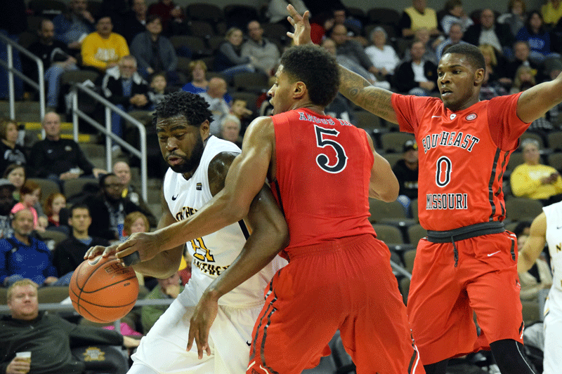 Jalen Billups (21) drives to the basket against Joel Angus III during Saturday's game at BB&T Arena.