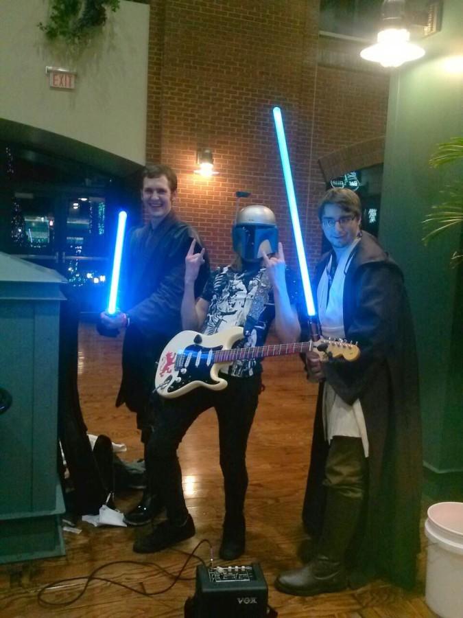 Jared Koshiol hangs out with other Star Wars fans. Koshiol is wearing a Jango Fett helmet.