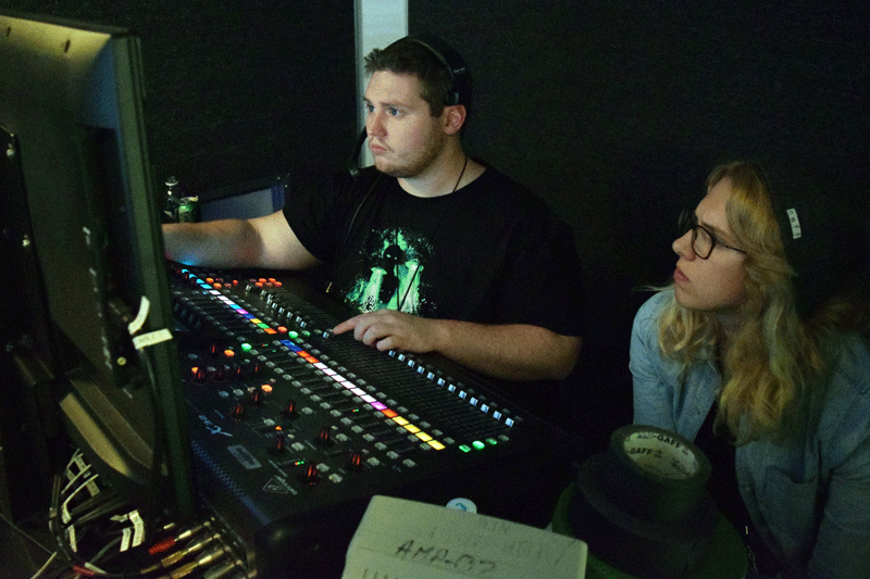 Audio engineer Jake Free (left) and Heidi Troll prepare for the broadcast to begin.