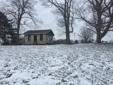 From the street, the cabin can be viewed when entering campus. The cabin is currently being restored.