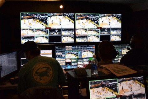 Elliot Ringo (left), Bill Farro (center) and Wes Akers (right) look at the large video wall as the game gets underway.