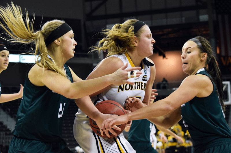 Kasey Uetrecht (23) fights off two defenders during Thursdays game against Green Bay.