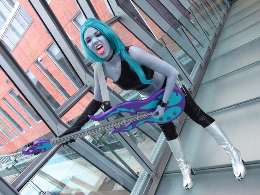 Koehler is portrayed as Ember from Danny Phantom. Props are often used in cosplays such as her guitar. 