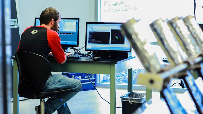 Carter Kring, a sophomore physics major,  checks simulations daily to read the symbols received from the detector in the Cream experiment. The detector will journey to the International Space Station next year.