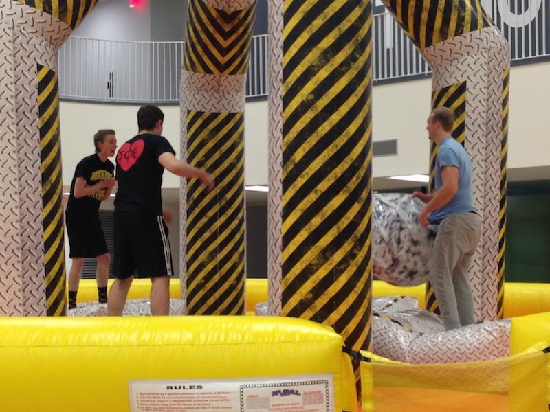 Students try their best to knock each other off balance with the wrecking ball, also one the new popular activities at the homecoming festival. 