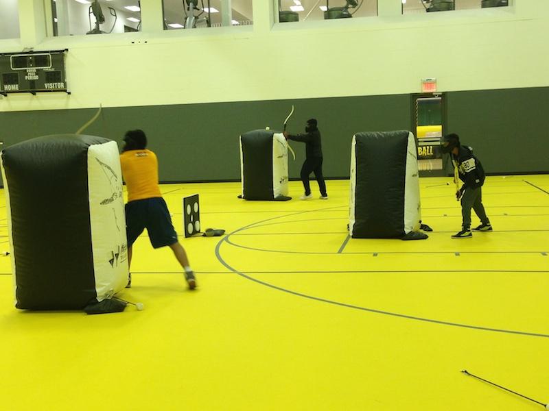  Students try to shoot their opponents while enjoying archery tag, one of the new activities for the homecoming festival. 