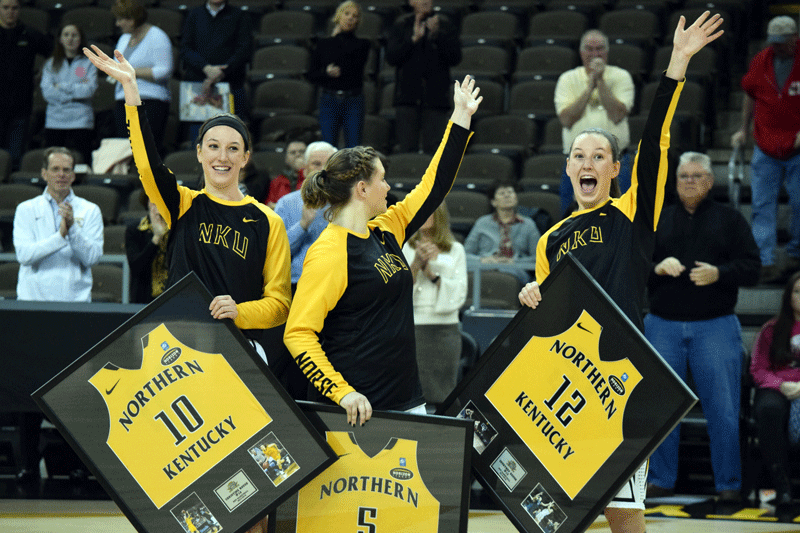 Christine Roush (10), Rianna Gayheart (5) and Courtney Roush (12) wave to the BB&T Arena crowd following senior night festivities Saturday night.