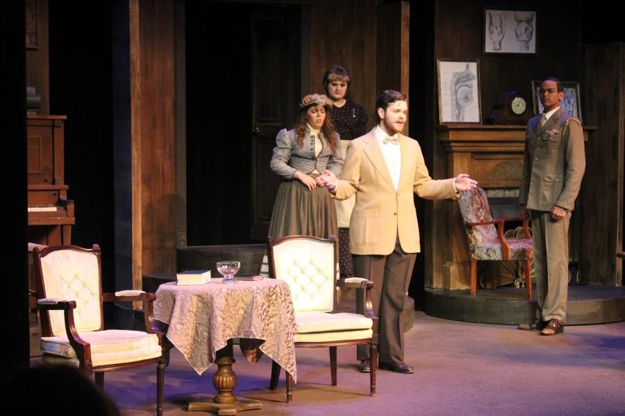 In this picture the characters are Eliza Doolittle played by Audrey Macneil, Henry Higgins played by Justin Woolums and Colonel Pickering played by Taylor Greatbatch. In this scene Higgins is telling Eliza she needs to get cleaned up.