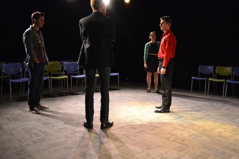 The full cast of "Cock" rehearsing a tense scene.