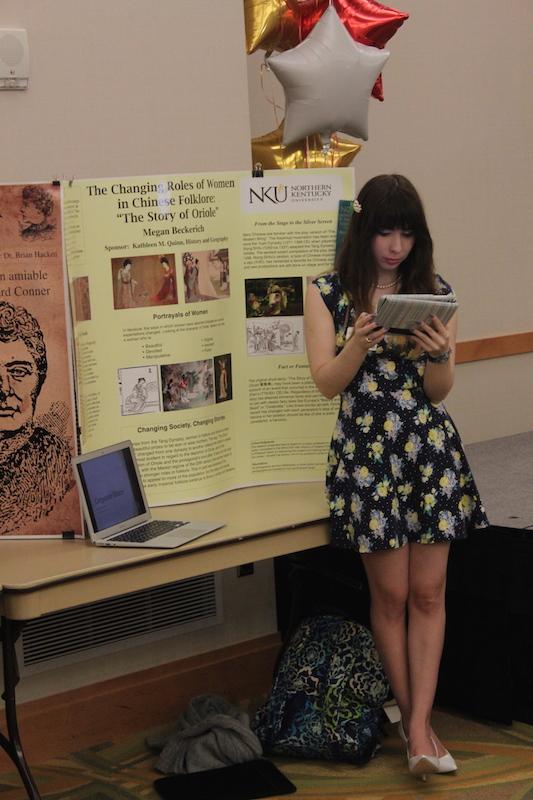 Kathleen Quinn, a senior at NKU, showcases her research on the changing roles of women in Chinese folklore.