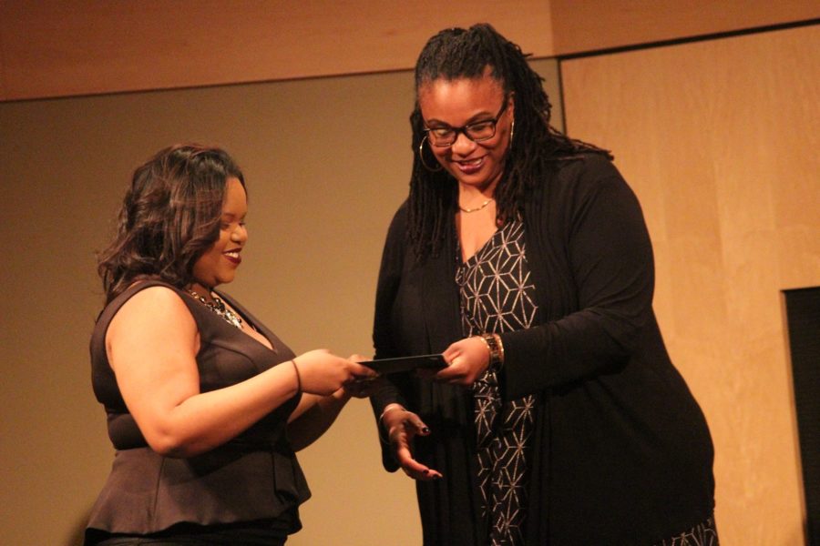 Tracy Stokes, director of African American Programs and Services, awards RonNiscia Cole and

other freshman R.O.C.K.S scholars the Gold, Black and White Awards of academic  achievement to students with GPAs of a 3.0 to a 4.0.