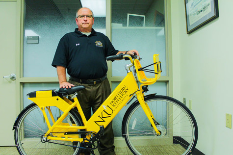 Andy Meeks, director of business operations and auxiliary services, poses with one of the new bikes. Meeks is partially responsible for bringing a bike share to campus.
