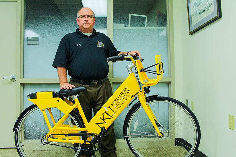 Andy Meeks, director of business operations and auxiliary services, poses with one of the new bikes. Meeks is partially responsible for bringing a bike share to campus.  