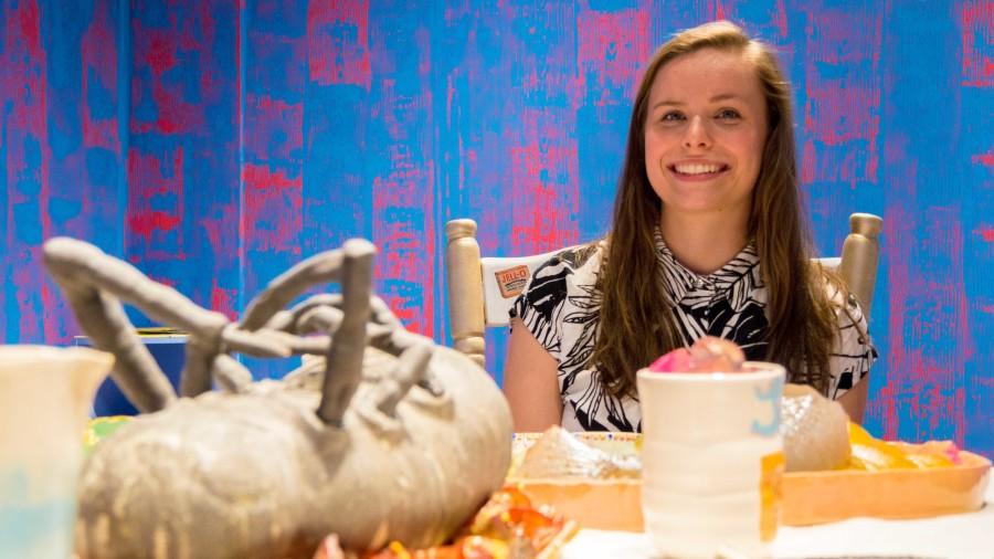 Emma Clixby, BFA spatial arts major, tries to bring awareness with her exhibit “Consumed.” Featuring a dining room with a sculpted food and plates, Clixby focuses on consumerism in America.