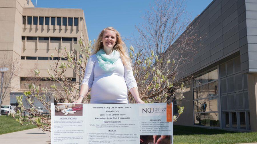 Abagaile Long, a student in the Master's program for social work, poses on campus with her project. Long's findings showed that nearly 82 percent of her sample group used an illicit drug in the past year.