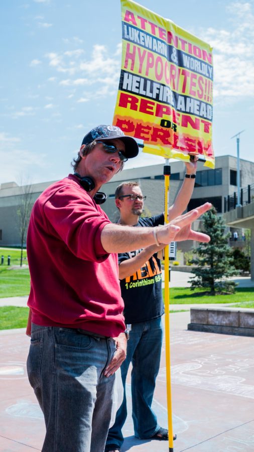 Toting signs with messages of condemnation, two street preachers spouted their message on campus April 20. The duo was set up in the amphitheater overlooking Loch Norse.  