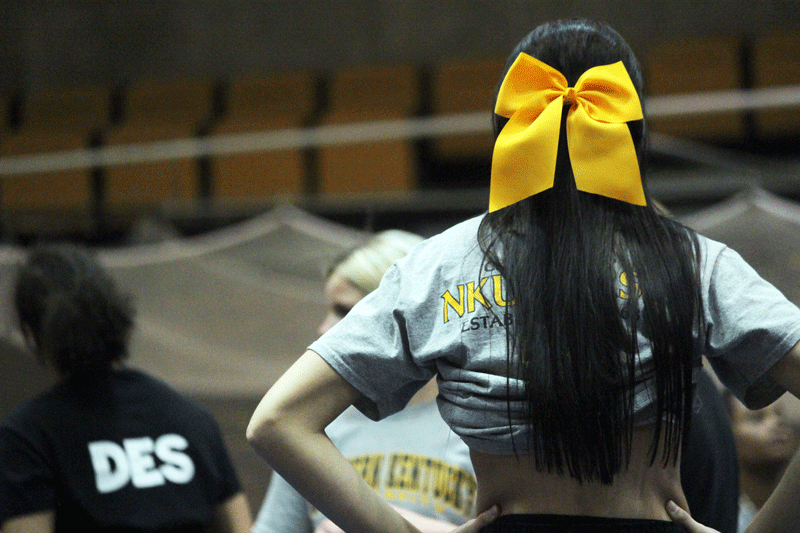 Desiree Allen, Brooke Berry, Megan McDonough prepare for cheerleading practice.