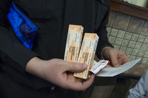 Lt. John Gaffin holds the contents of his naloxone kit. Gaffin was involved in issuing the general order, which allowed officers to carry the drug.