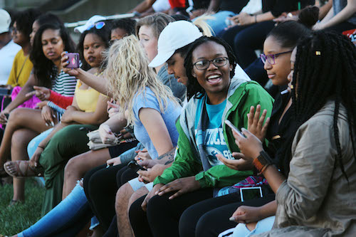 Audience gathers in front of Loch Norse to watch Greek fraternities and sororities gather.