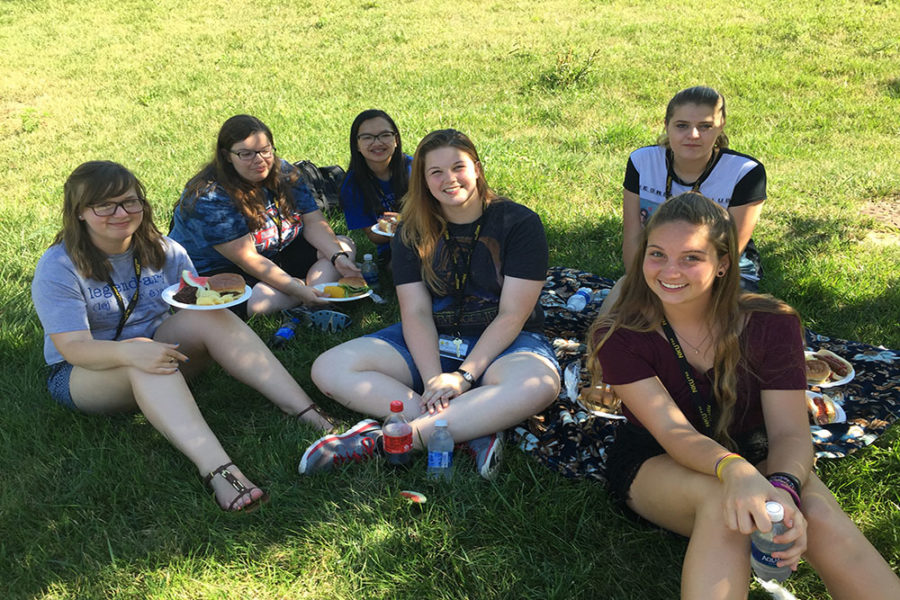 NKUs scholars discuss their experiences at the programs cookout. 