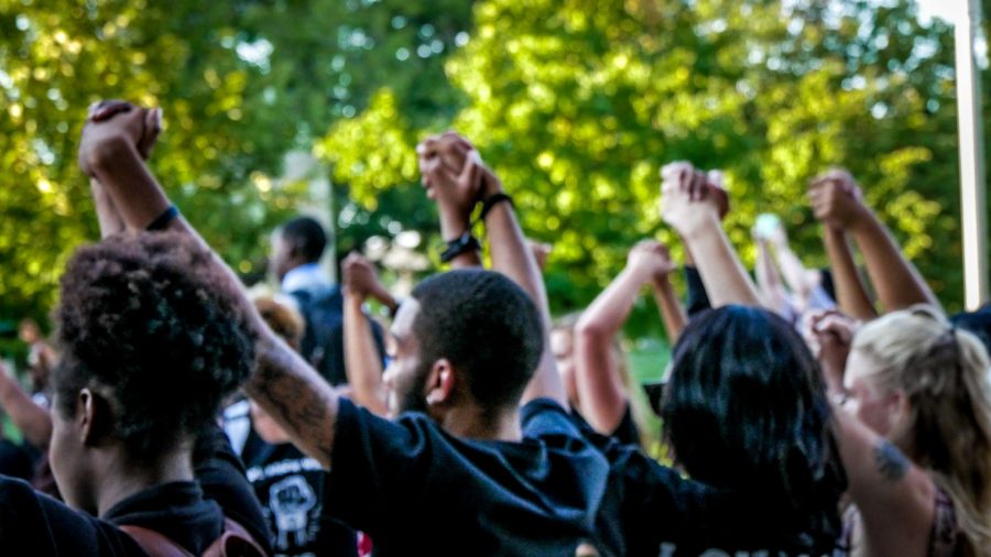 Hand-in-hand%2C+students+chanted+messages+of+hope+at+the+end+of+the+demonstration.+