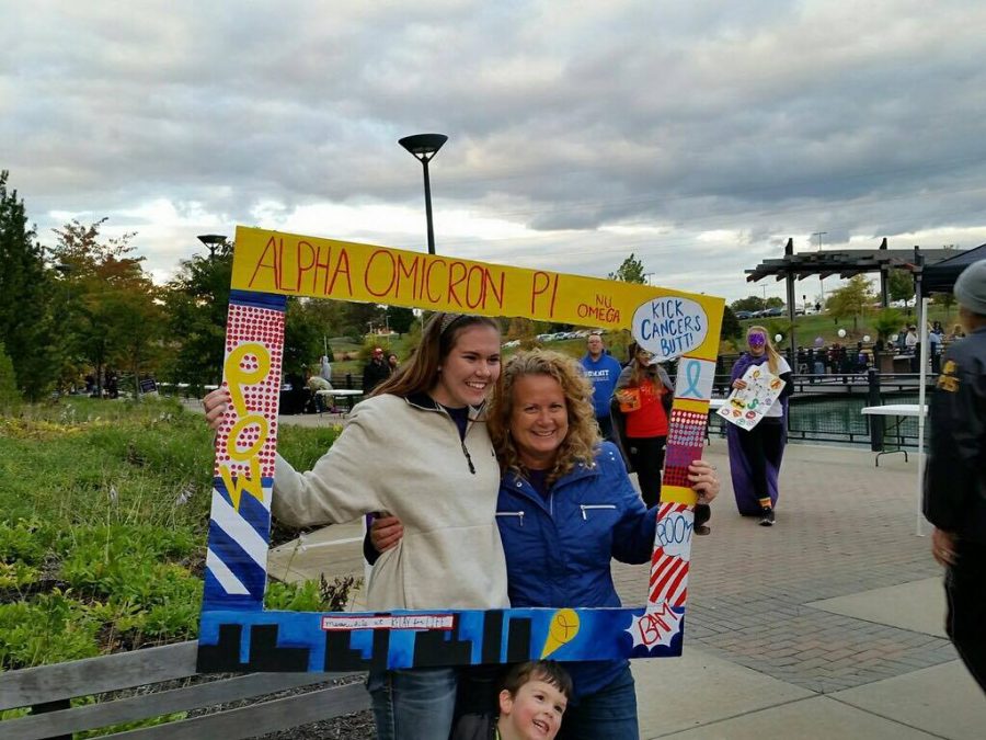 Alli Otten (left) and her mother pose with a frame Otten's sorority made in honor of Relay for Life to support those who have been affected by cancer.