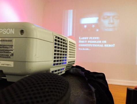 Images projected along the wall, attendees were warned that they may find some of the images distasteful. The lecture was presented by Jennifer Kinsley.