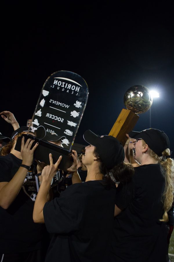 The NKU Norse hold up the Horizon League trophies after beating Milwaukee 3-2 in the championship game.