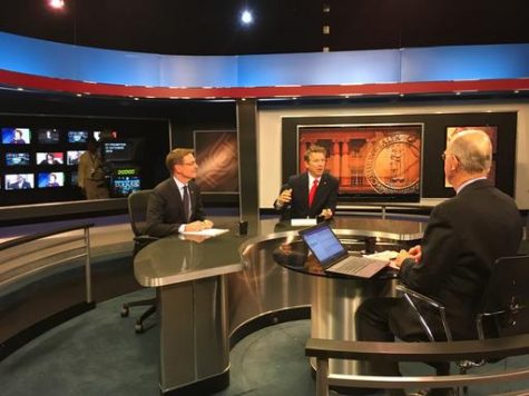 Kentucky U.S. Senate candidates Jim Gray, left, and Rand Paul talk with moderator Bill Goodman shortly before the start of a televised debate in Lexington, Ky., Monday, Oct. 31, 2016. (AP Photo/Adam Beam)