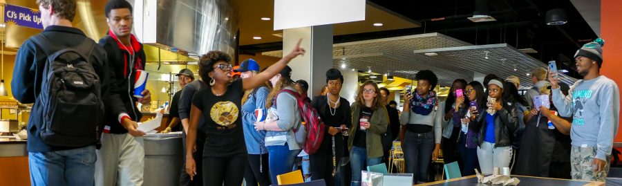 Hand pointed in the air, a crowd gathered around Mekkah Moore. Her poetry elicited applause from bystanders. 