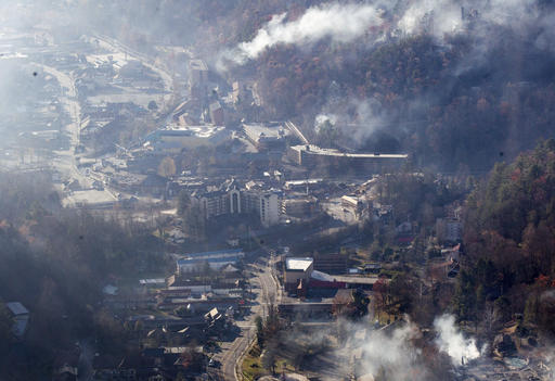 Burned structures are seen from aboard a National Guard helicopter near Gatlinburg, Tenn., Tuesday, Nov. 29, 2016. Thousands of people raced through a hell-like landscape to escape wildfires that killed several people and destroyed hundreds of homes in the Great Smoky Mountains. (AP Photo/Erik Schelzig)