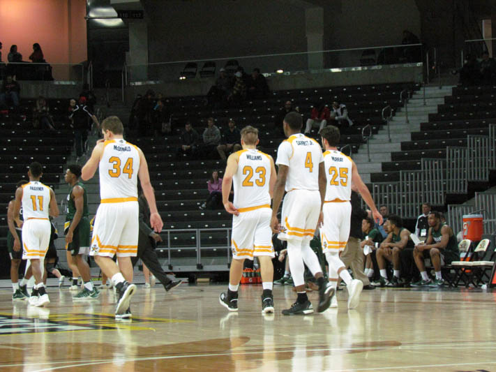 Drew McDonald (34), Carson Williams (23), Jeff Garrett (4), and Cole Murray (25) walk on to the court after a timeout.