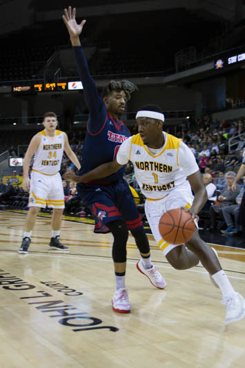 Jordan Garnett dribbles down the baseline against a Detroit Mercy defender. The Norse would beat the Titans 101-87