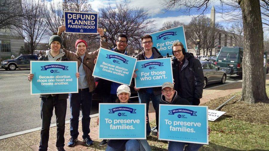 Northern Right to Life members show their protest signs at March for Life.