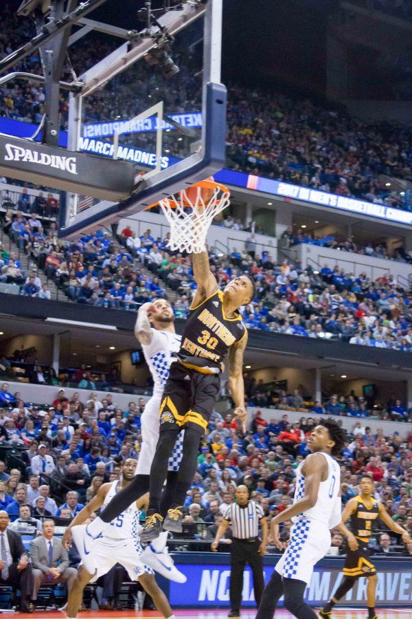 Lavone Holland (30) throws down a thunderous dunk during Fridays NCAA tournament game against Kentucky.