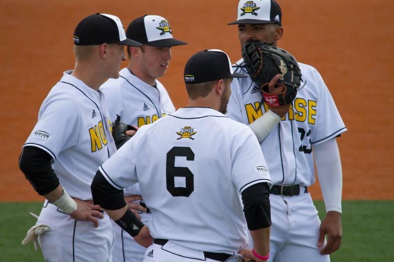 The Norse infield talks things over during a pitching change