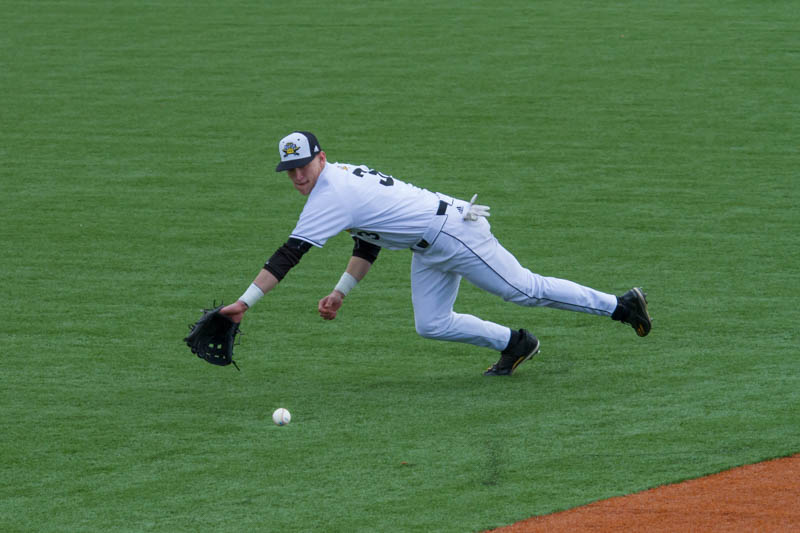 Jake Richmond makes a diving stop at short stop. He hit two homeruns on the day 