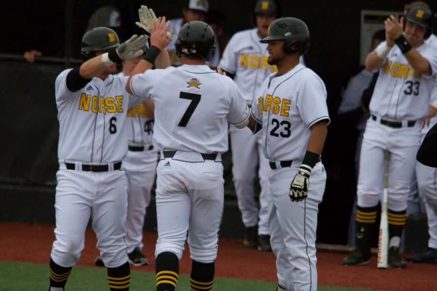 TJ Alas celebrates with teammates after hitting a homerun. Alas hit two homeruns on the day.