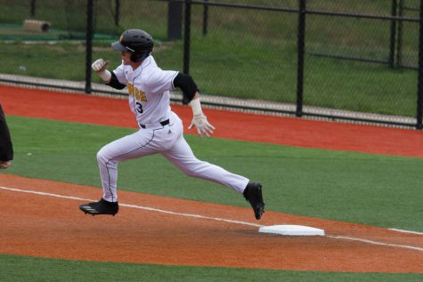 Jake Richmond rounds first base trying to stretch a single into a double.